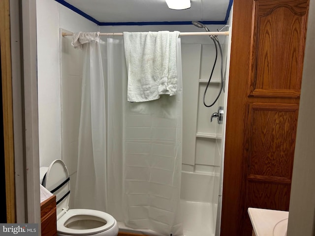 bathroom featuring a shower stall and toilet