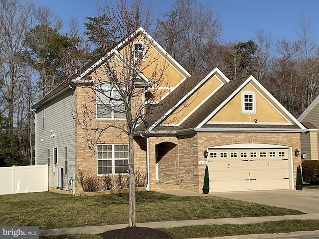 traditional-style home featuring brick siding, a front lawn, fence, a garage, and driveway