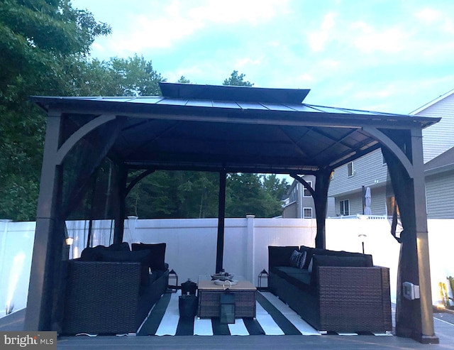 view of patio with a gazebo, an outdoor living space, and fence