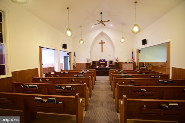 misc room featuring a wainscoted wall, carpet floors, wooden walls, and arched walkways