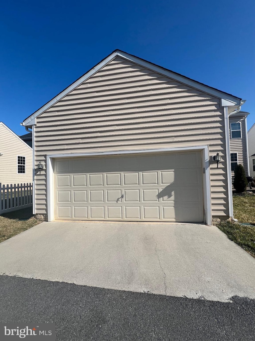 garage with driveway and fence