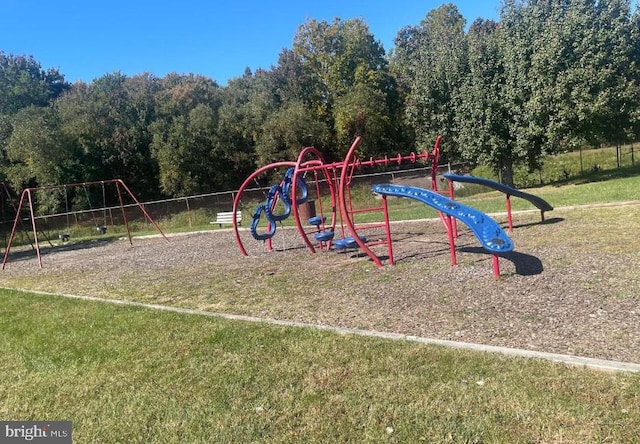 communal playground featuring a yard