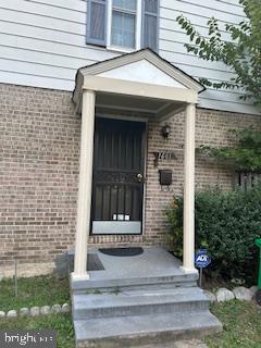 doorway to property featuring brick siding