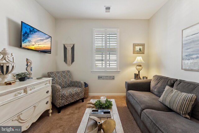 carpeted living area with baseboards and visible vents