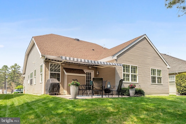 back of house featuring a patio, a shingled roof, and a lawn