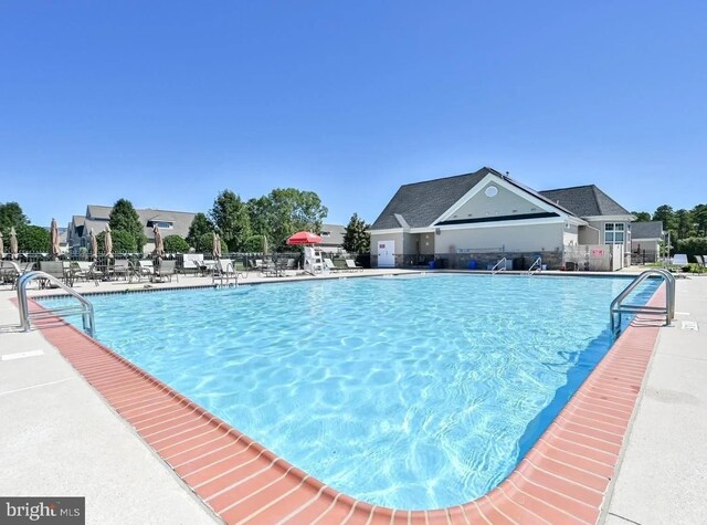 pool featuring a patio area and fence