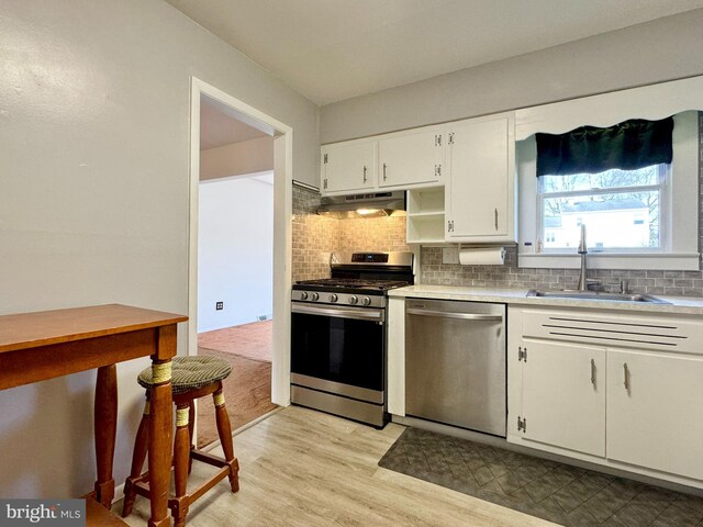 17 Acton, Ewing, NJ 08618 - kitchen with under cabinet range hood, backsplash, appliances with stainless steel finishes, and a sink