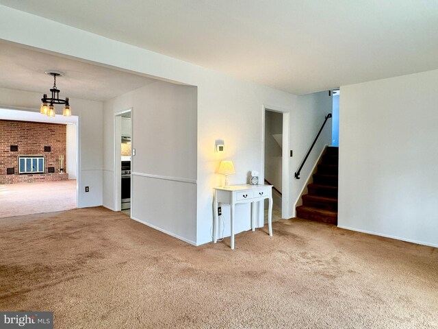 17 Acton, Ewing, NJ 08618 - unfurnished living room featuring a notable chandelier, a fireplace, stairs, and carpet floors