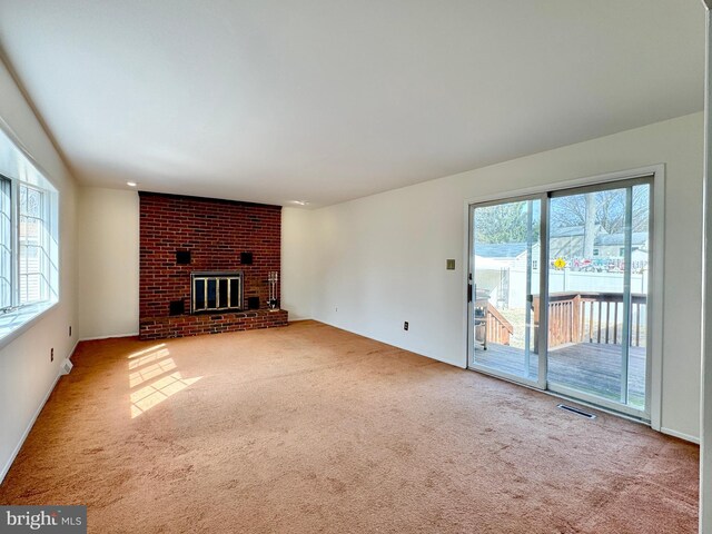 17 Acton, Ewing, NJ 08618 - unfurnished living room featuring visible vents, carpet, and a brick fireplace