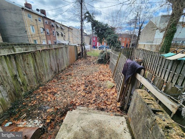 view of yard with a residential view and fence