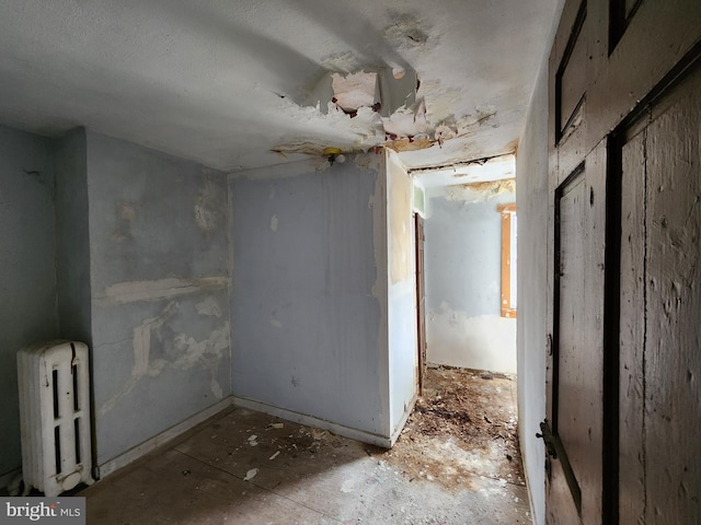 empty room featuring radiator heating unit