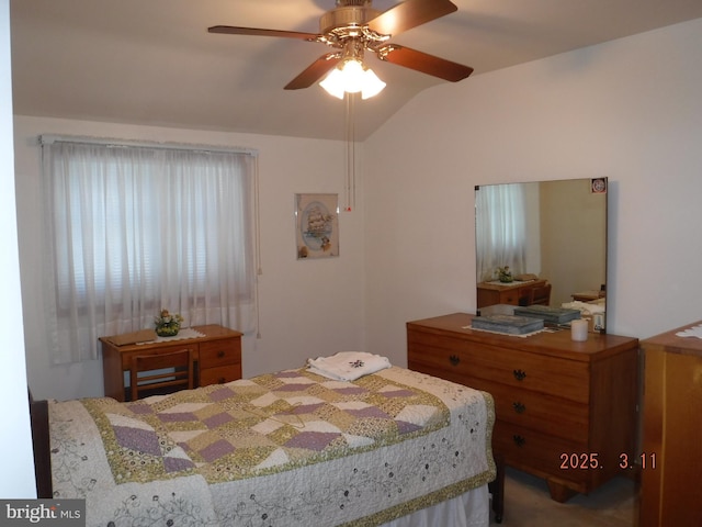 bedroom with a ceiling fan and lofted ceiling