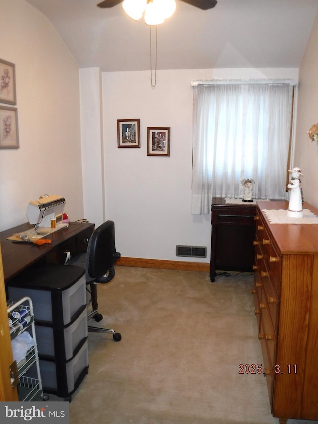 office with visible vents, baseboards, carpet, lofted ceiling, and a ceiling fan