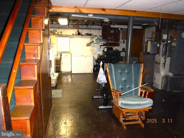 below grade area with refrigerator and heating unit