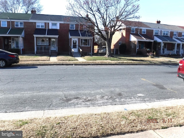 view of street featuring sidewalks, a residential view, and curbs