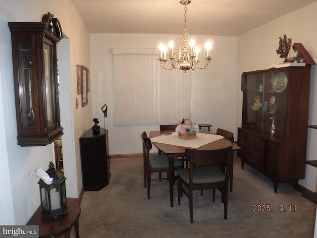 dining space with an inviting chandelier, baseboards, and carpet