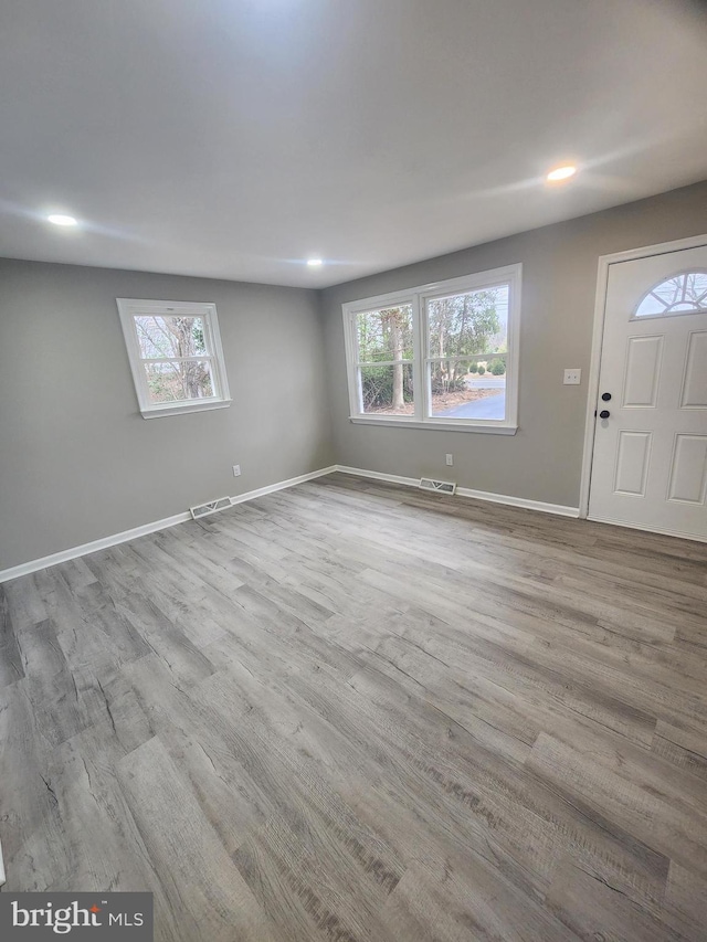 interior space featuring visible vents, recessed lighting, baseboards, and wood finished floors