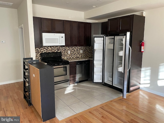 kitchen with visible vents, tasteful backsplash, appliances with stainless steel finishes, light wood finished floors, and dark brown cabinets