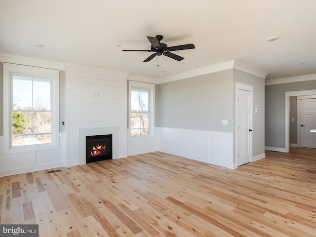 unfurnished living room featuring visible vents, a healthy amount of sunlight, crown molding, and light wood finished floors