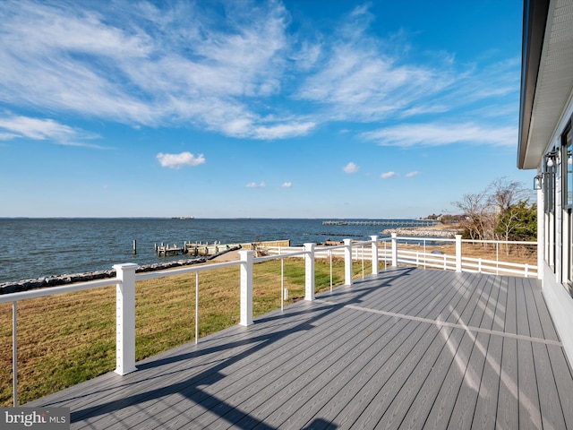 wooden deck with a yard and a water view