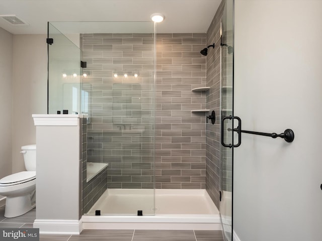 bathroom with visible vents and a stall shower