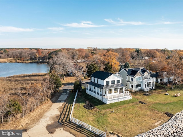 aerial view with a water view and a view of trees