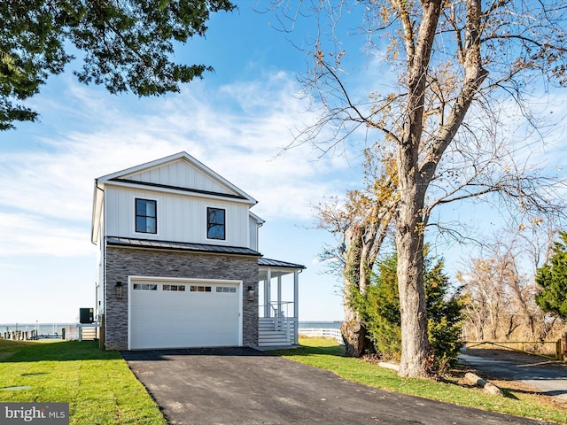 view of front facade with board and batten siding, metal roof, driveway, an attached garage, and a standing seam roof