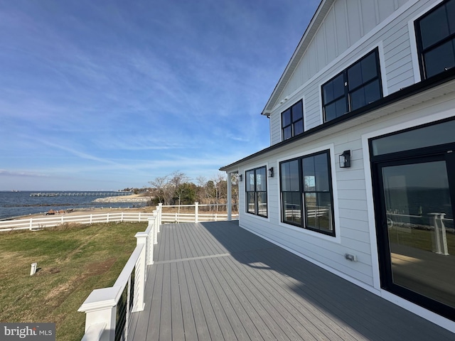 wooden deck featuring a yard and a water view