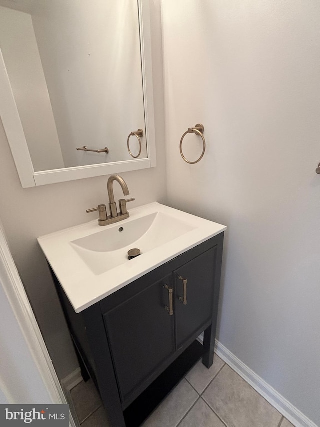 bathroom with vanity, tile patterned floors, and baseboards