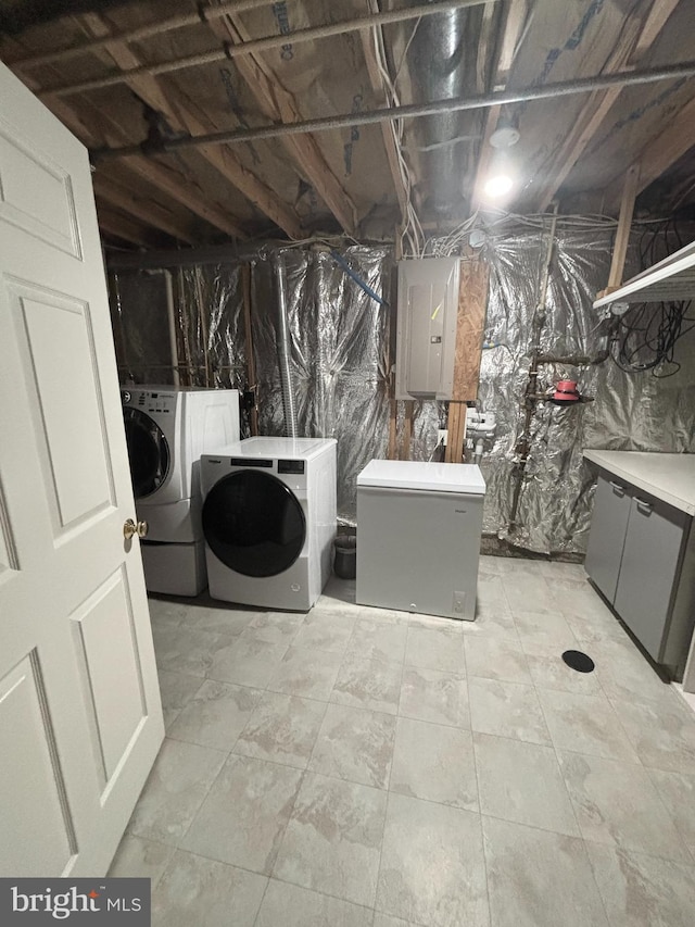 interior space featuring laundry area, electric panel, and washer and clothes dryer