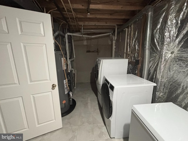 laundry area featuring gas water heater, independent washer and dryer, and laundry area