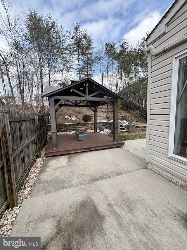 view of patio featuring a gazebo and a fenced backyard