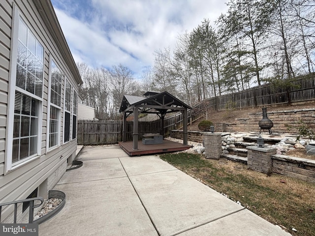 view of patio / terrace with a gazebo, a fenced backyard, and a wooden deck