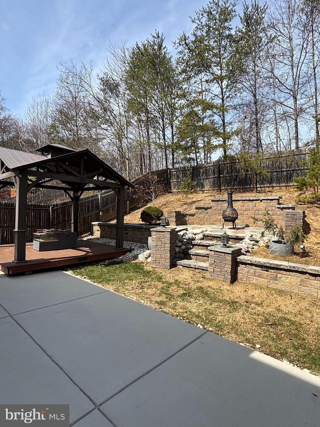 view of yard with a gazebo, a fenced backyard, and a patio area