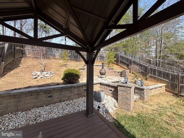 deck with a patio and a fenced backyard