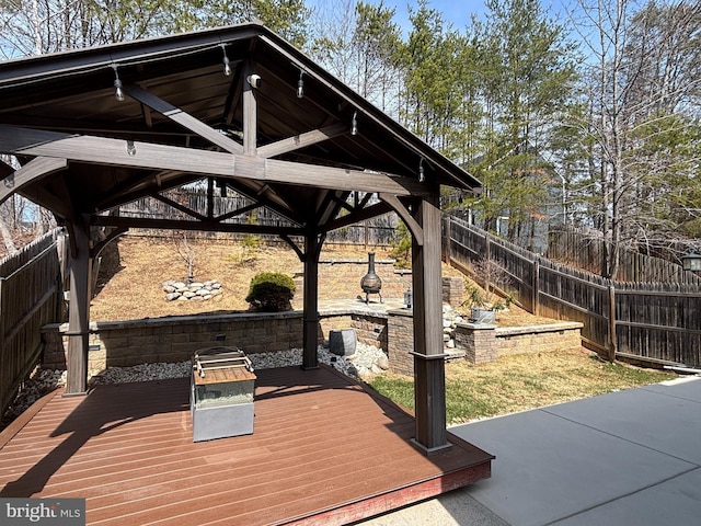 wooden terrace featuring a fenced backyard