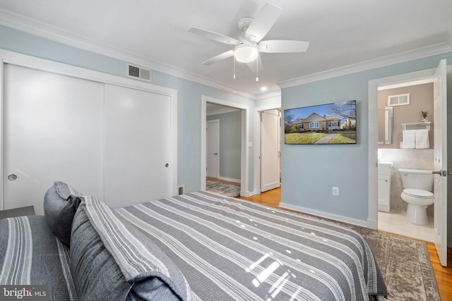 bedroom with visible vents, a closet, and ornamental molding