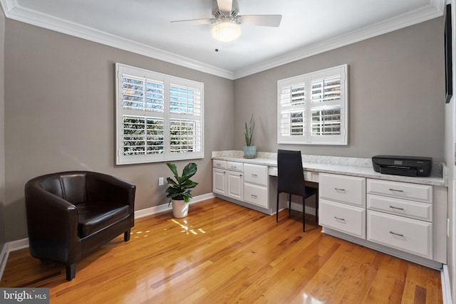 office area with ceiling fan, light wood-type flooring, crown molding, and baseboards