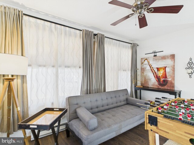 interior space with wood finished floors, baseboard heating, and ceiling fan