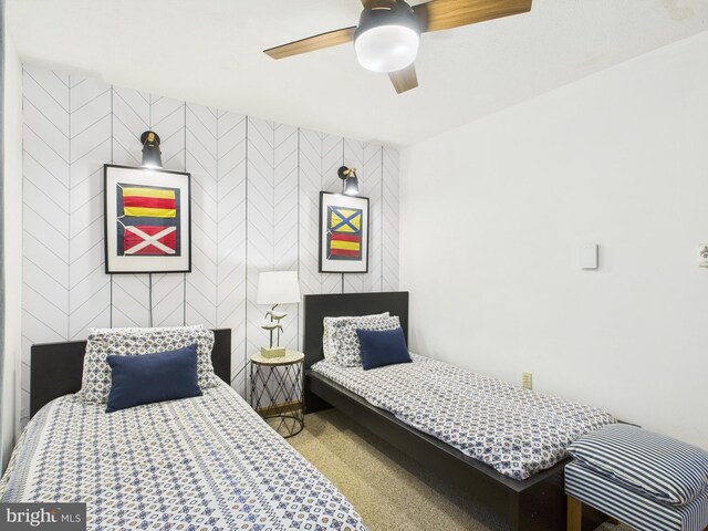 bedroom featuring ceiling fan and carpet