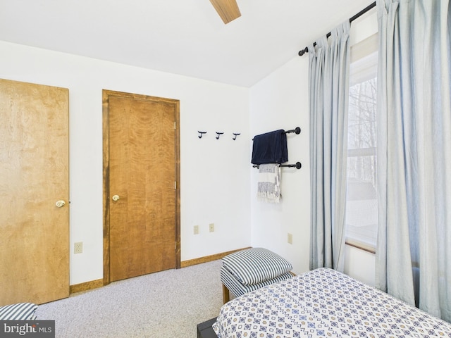 carpeted bedroom featuring ceiling fan and baseboards