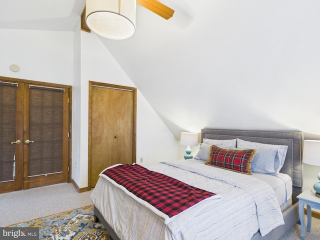 bedroom with a ceiling fan, lofted ceiling, and carpet