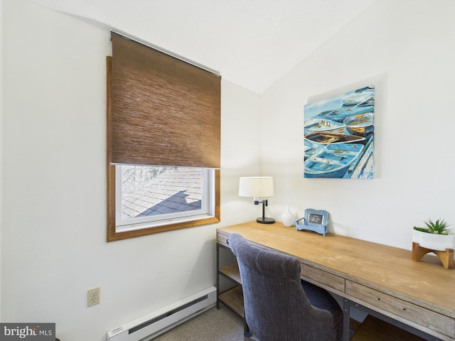 office space with baseboard heating, built in study area, and vaulted ceiling