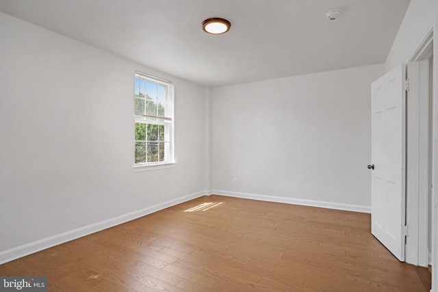 unfurnished bedroom featuring baseboards and wood finished floors