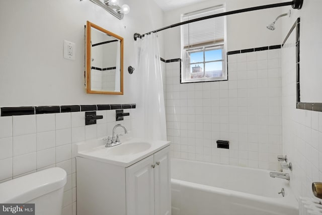 full bathroom featuring vanity, toilet, tile walls, and shower / tub combo with curtain