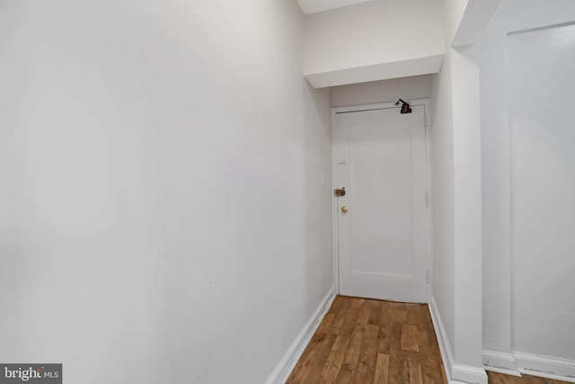 interior space with baseboards and wood finished floors