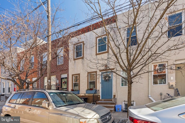 multi unit property featuring stucco siding and entry steps