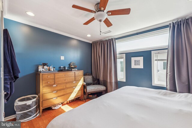 bedroom with wood finished floors, visible vents, recessed lighting, ceiling fan, and crown molding