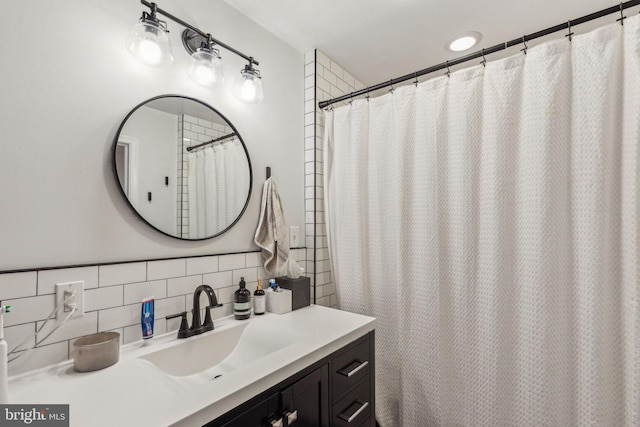 bathroom with decorative backsplash and vanity