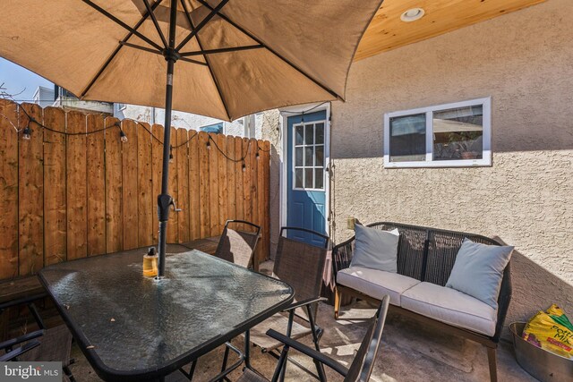 view of patio / terrace with outdoor dining space and fence